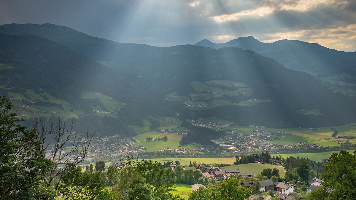 Dorf mit Bergen im Hintergrund nach einem Gewitter